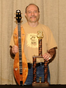 Mark Gilston with winning trophy and prize dulcimer at Winfield 2016